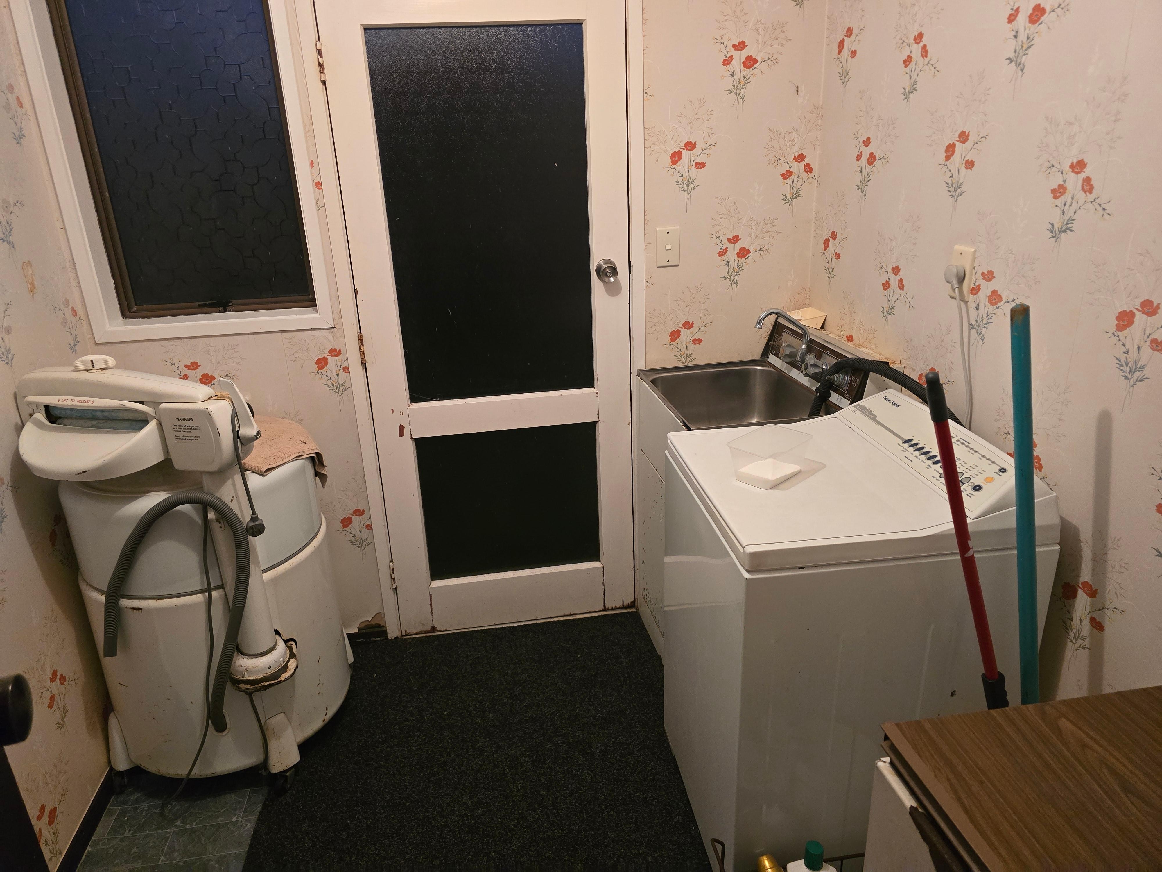 This is the room with the actual washer that is in the property; as opposed to the picture currently in the listing of a newer front-loading washer, the actual washer is an older-style top-loading washer.