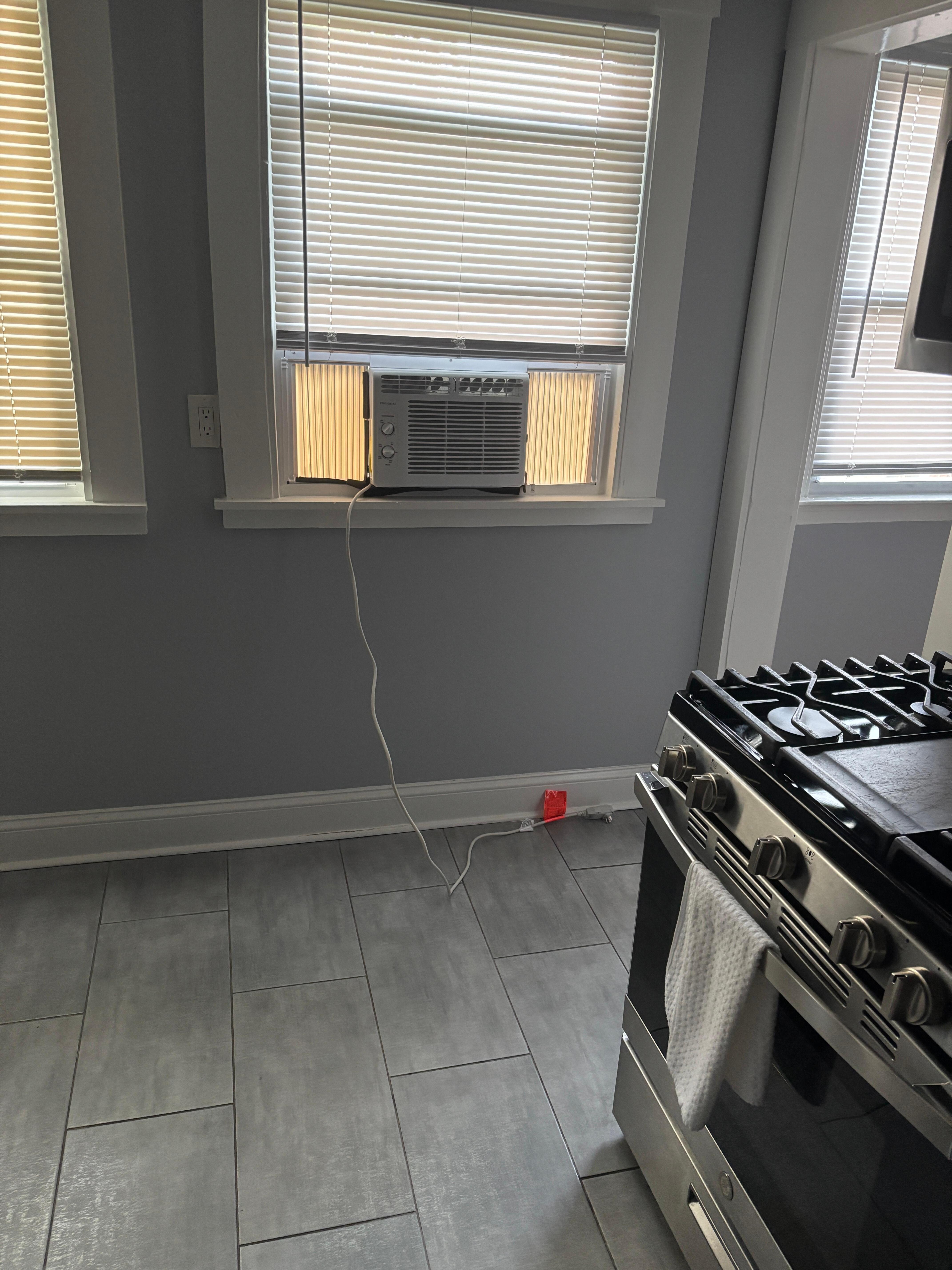 bare bedroom with window ac unit. Not like an oasis as described!