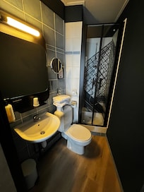 Small bathroom with shower, toilet and sink
