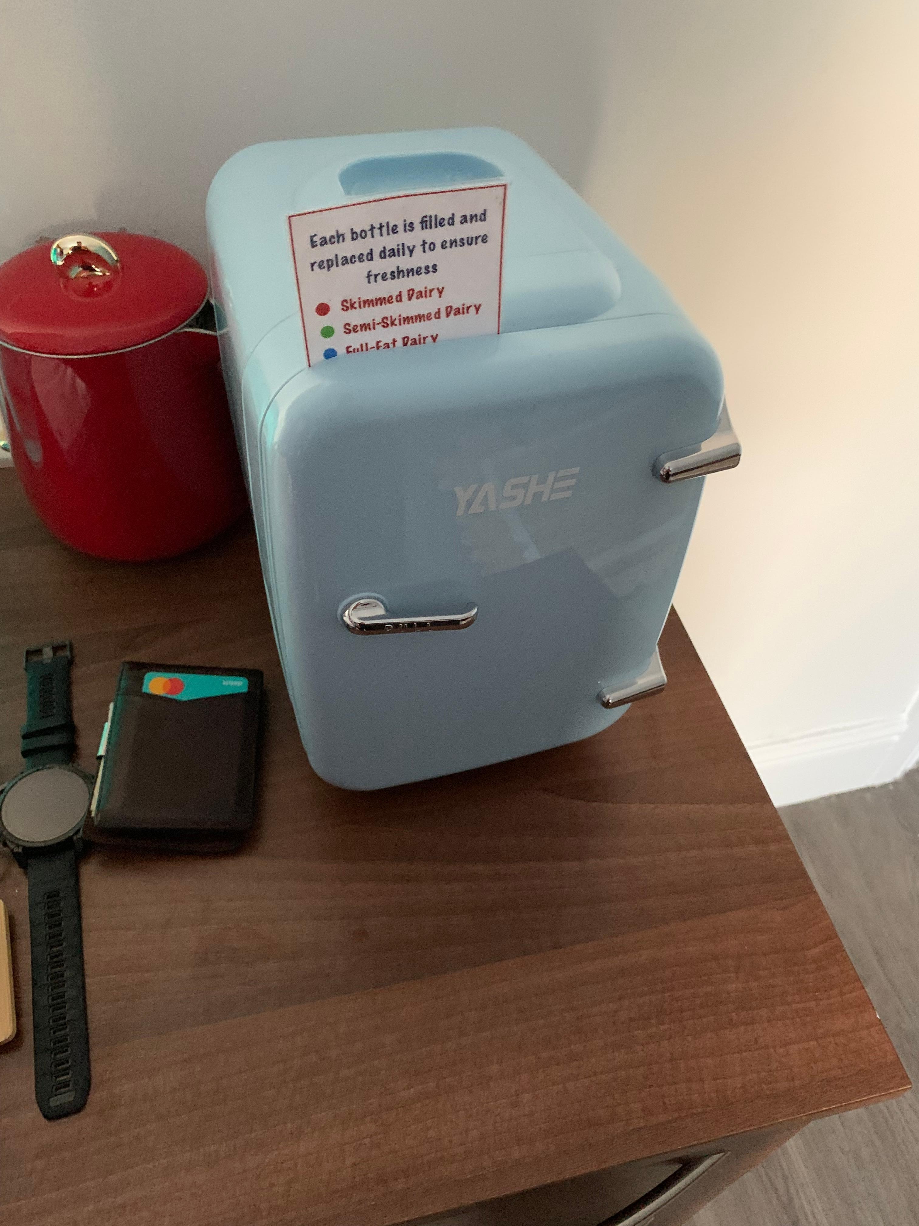 Cute little mini fridge in the left cabin room with tiny bottles of milk