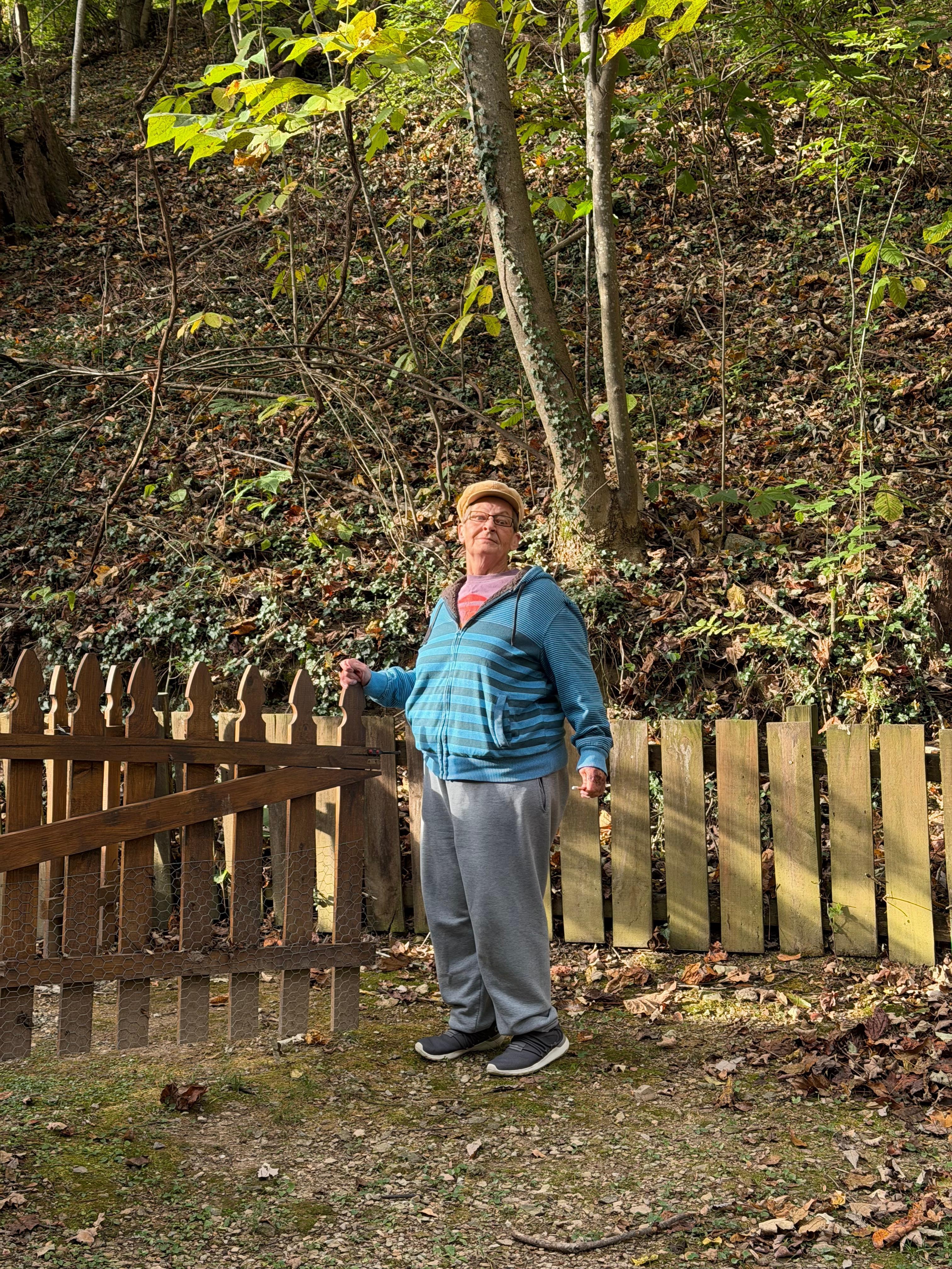 Sister standing in front of gate going up to the cabin