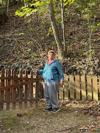 Sister standing in front of gate going up to the cabin