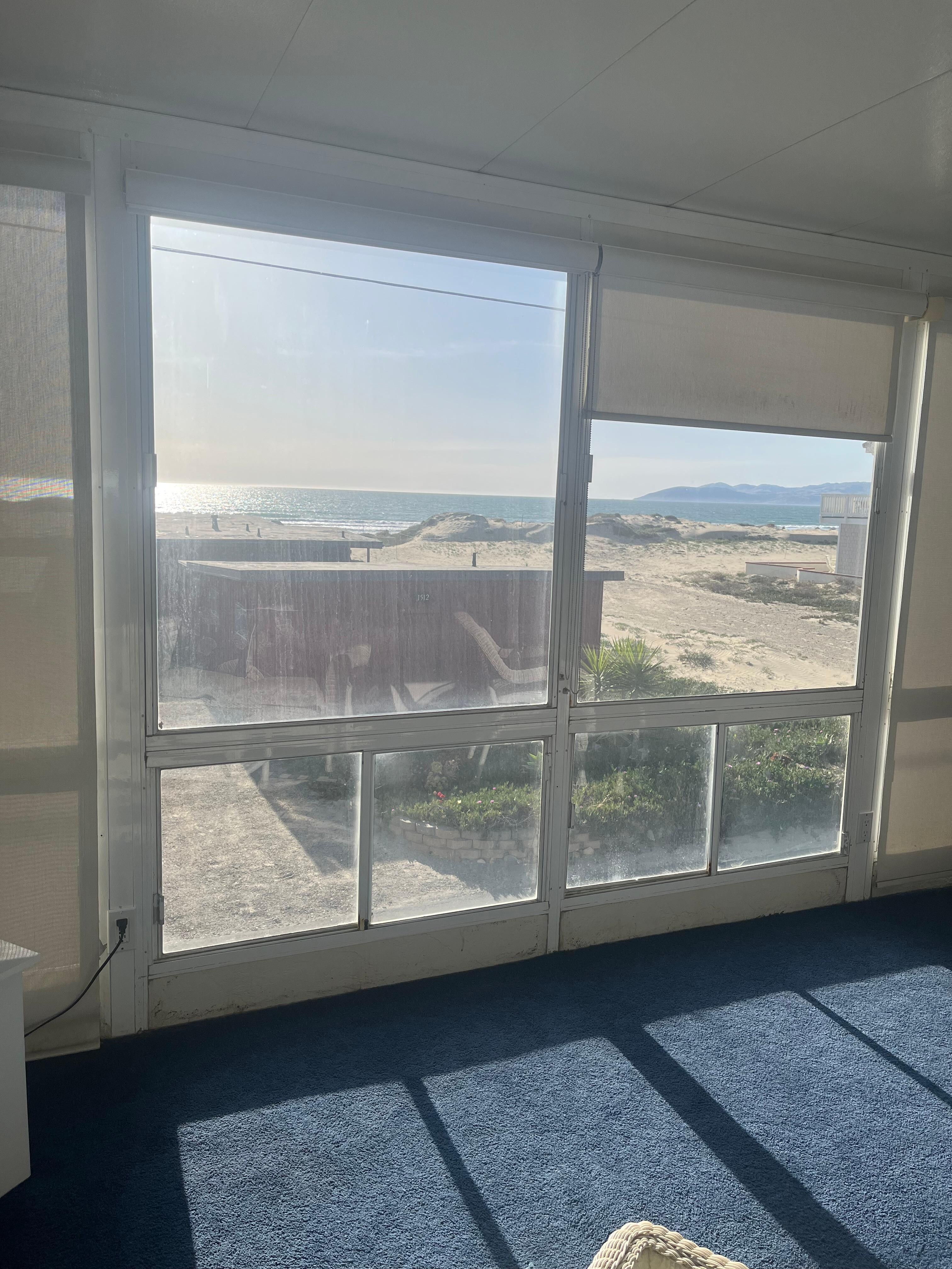 Sitting area upstairs is connected to two rooms and has a tv. 