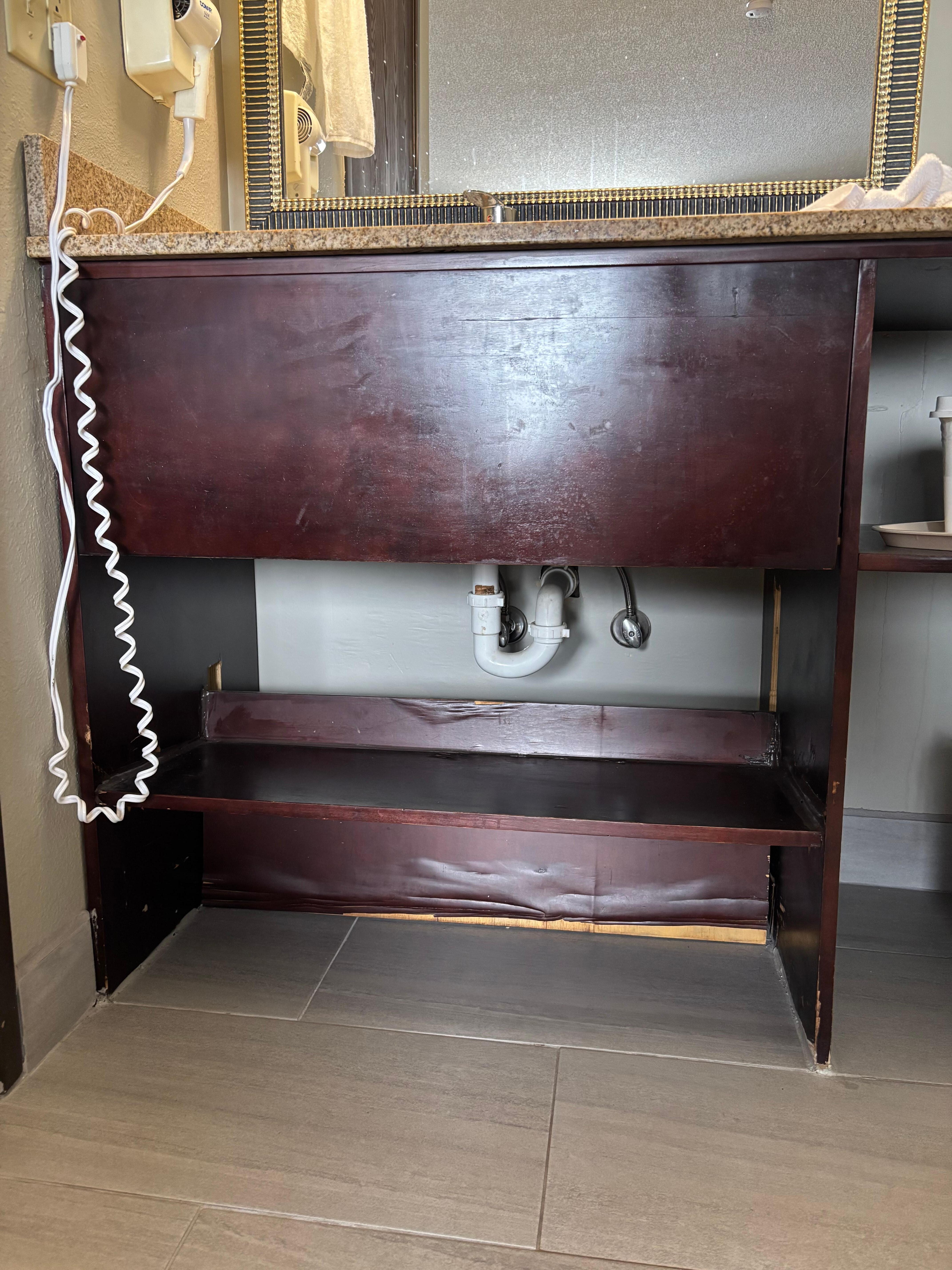 Water damaged shelving under the in-room sink
