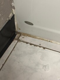 Corner of bathroom tile floor.