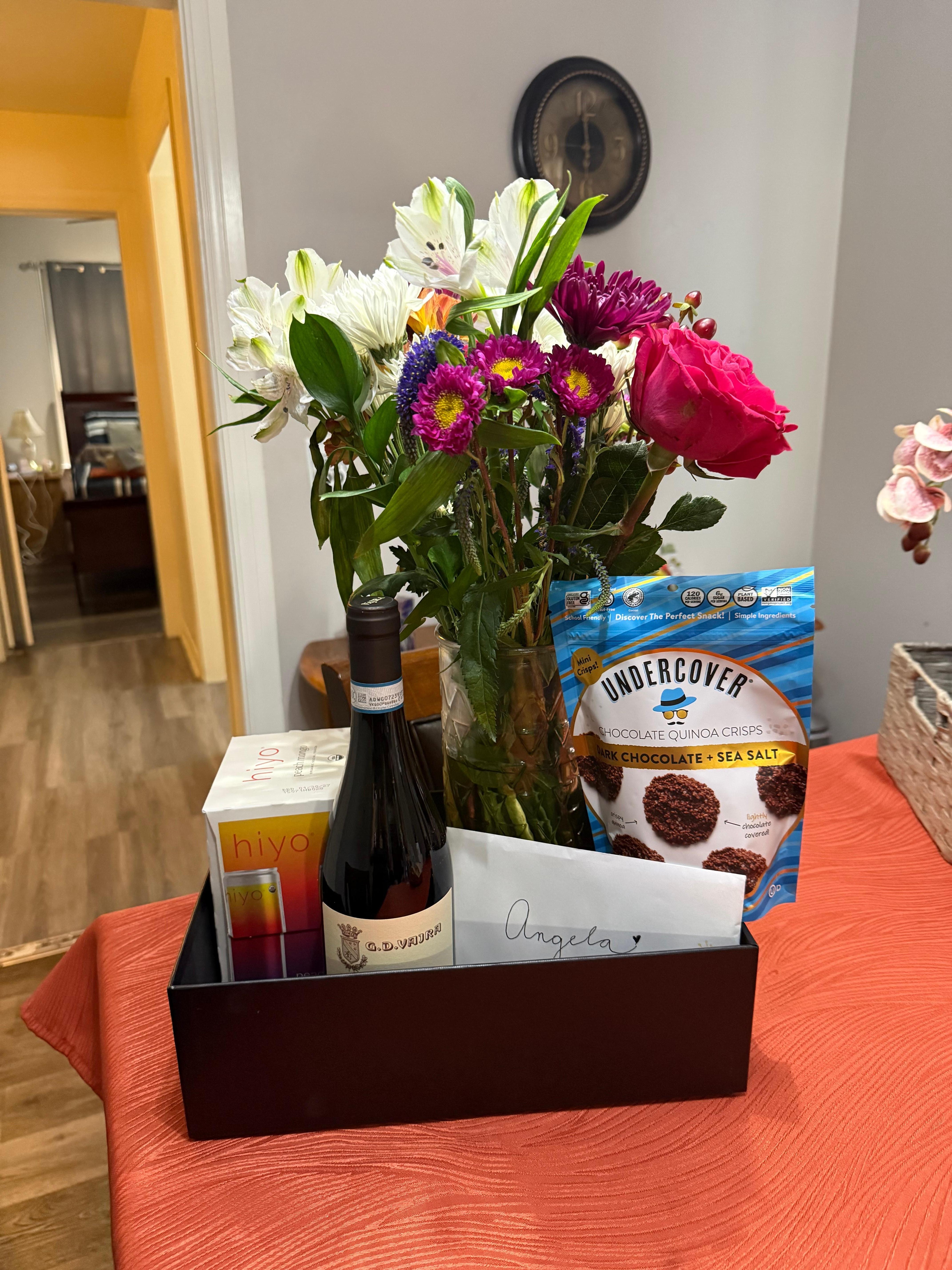 My daughter had some flowers and a sweet little goodie box for me when she picked me up from the airport. But this is the little dining area table, and you can see through the doorway is a little kitchen and then the bedroom :)