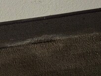 Baseboard under TV looks to have mold/mildew