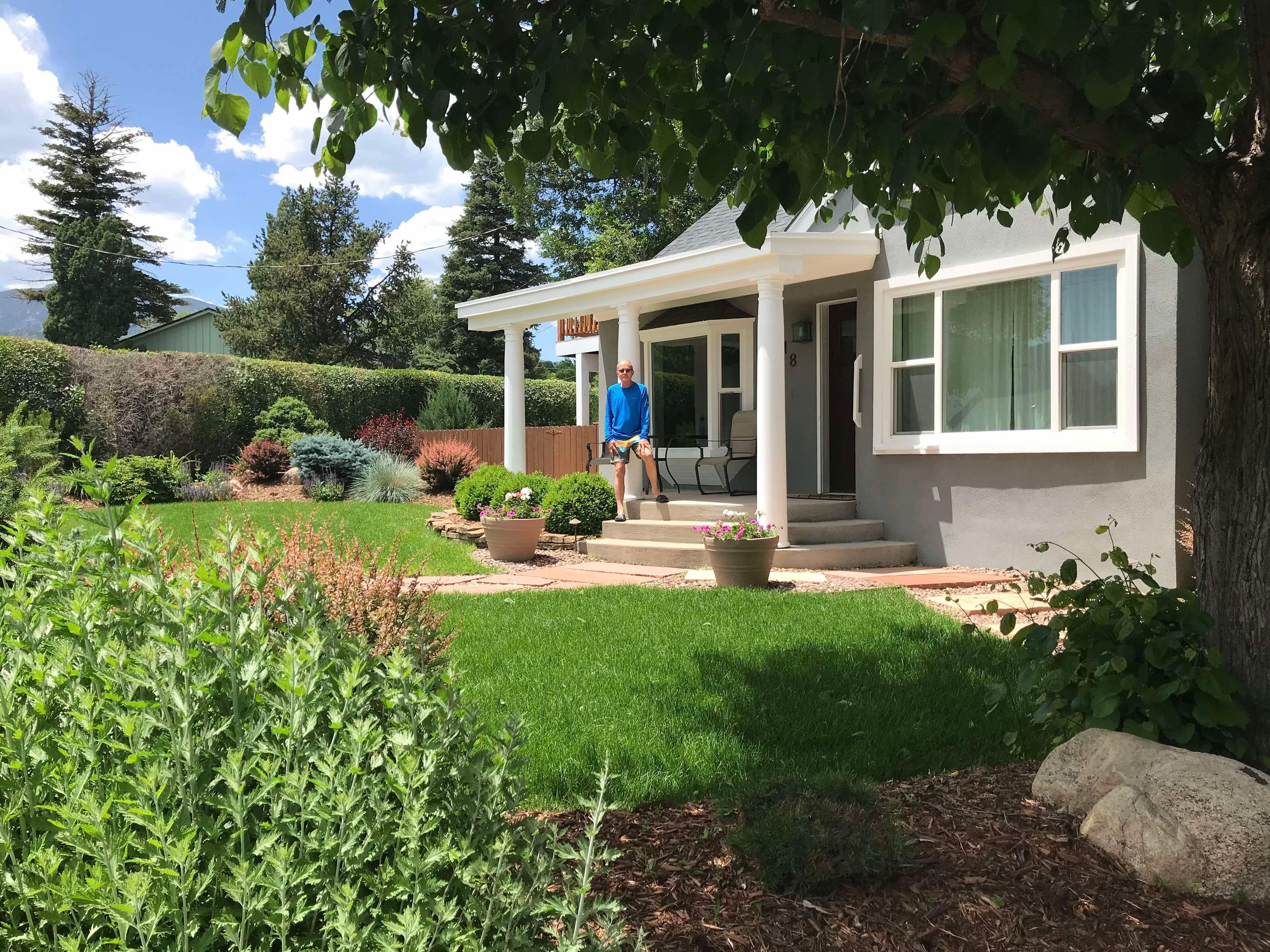 Harold posing in front of this cute little house. 