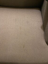 A very stained couch in our room.
