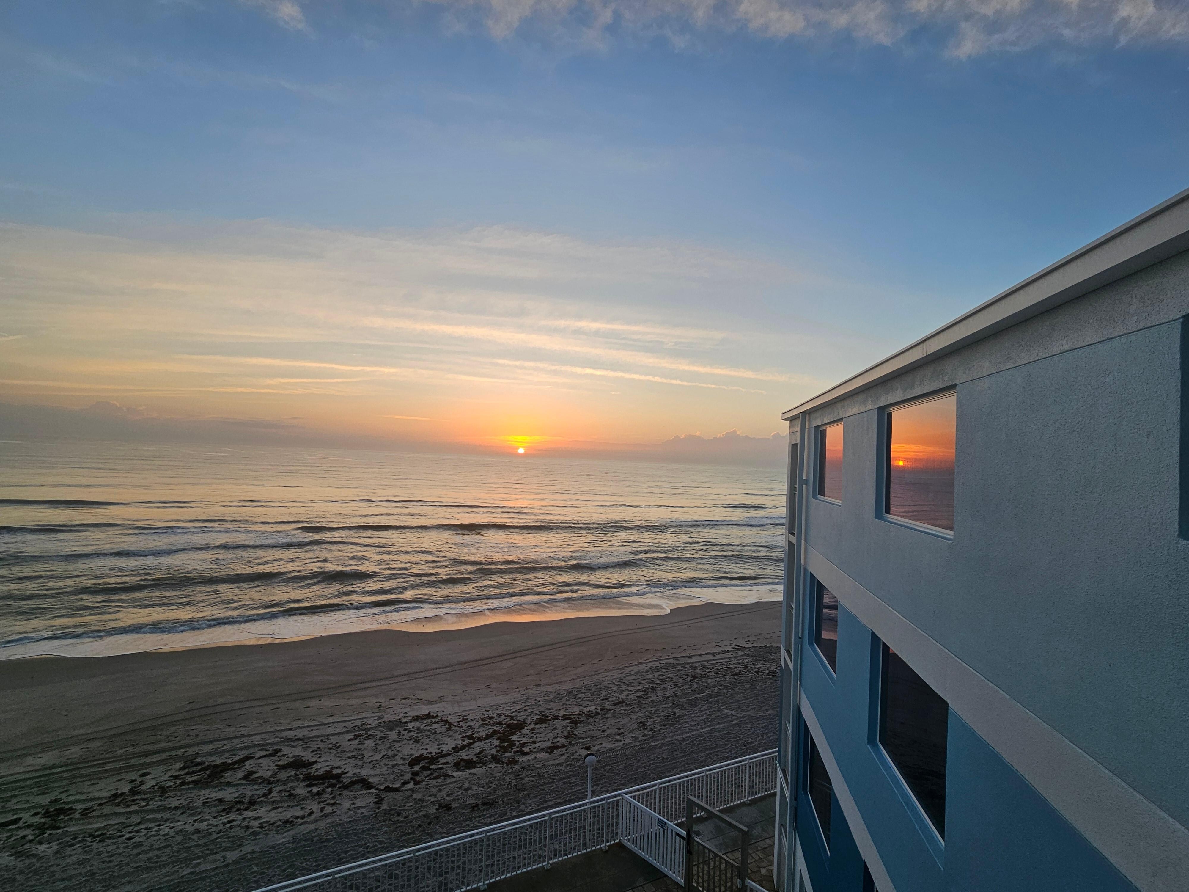 Sunrise from guest room balcony.  The top floor in this picture is the entire condo.