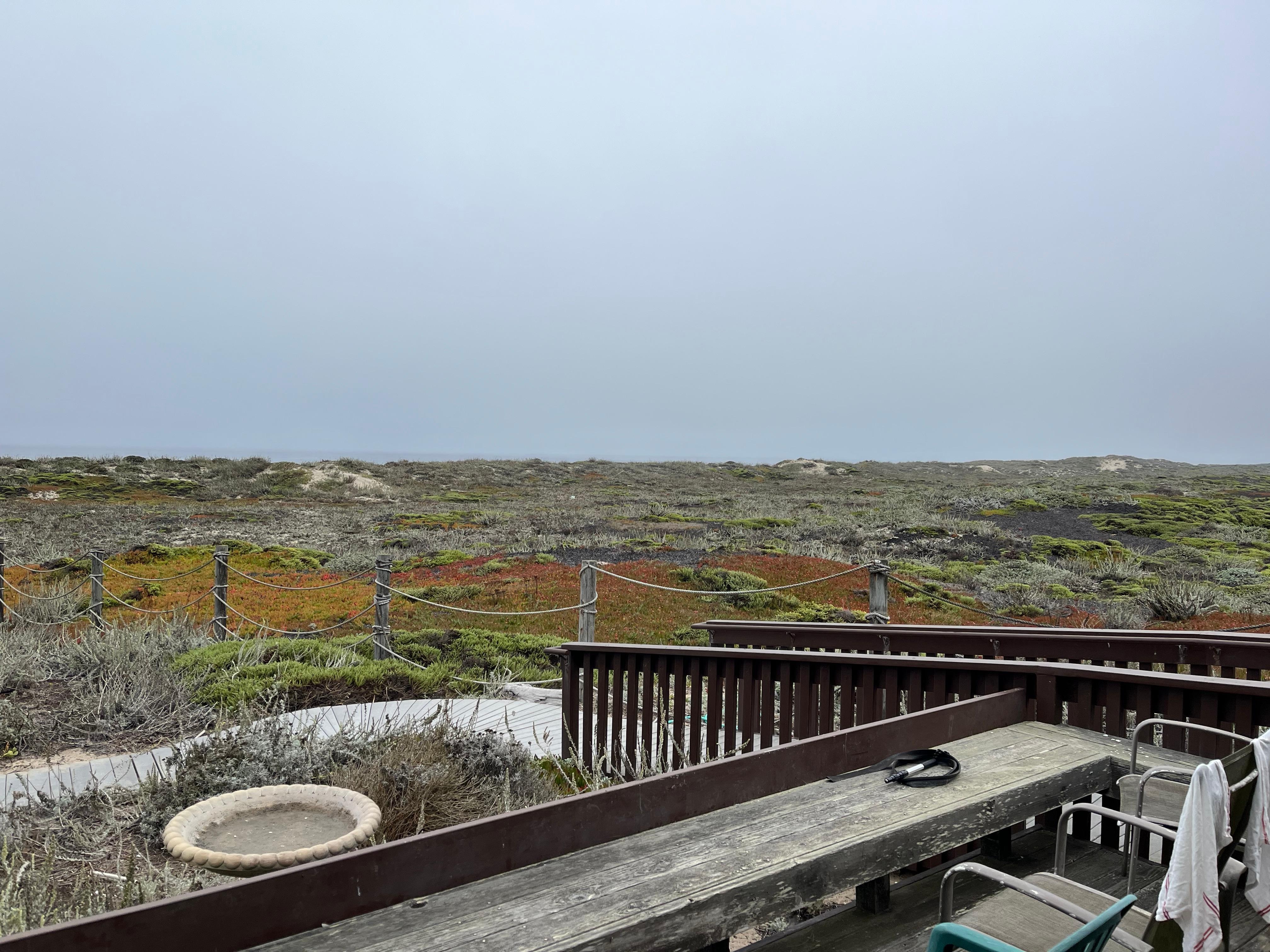 View from deck with dunes and ocean. 