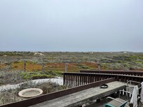 View from deck with dunes and ocean.