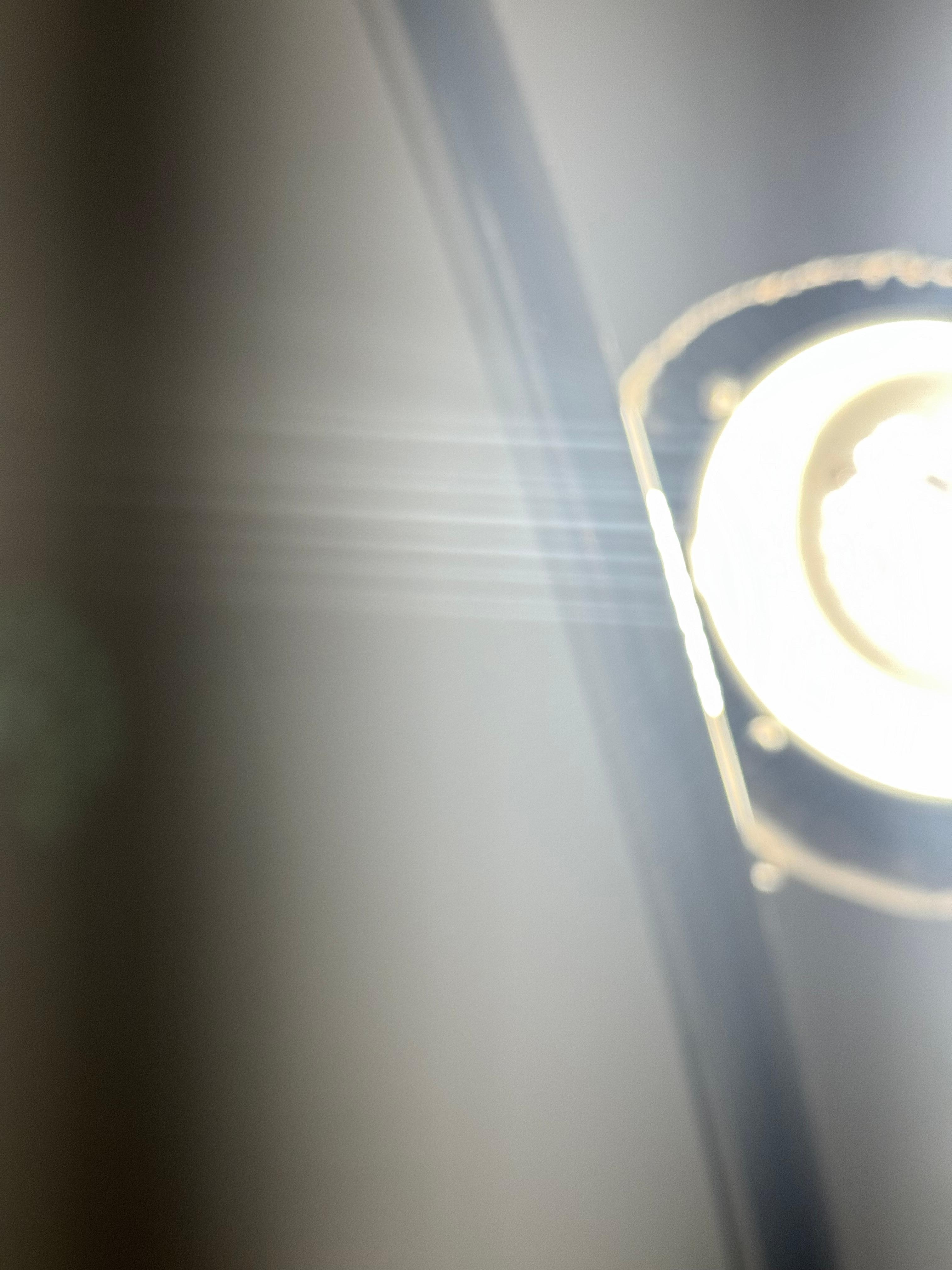 This is the light fixture in the bathroom. Not finished. Debris from the ceiling visible and probably in the air 