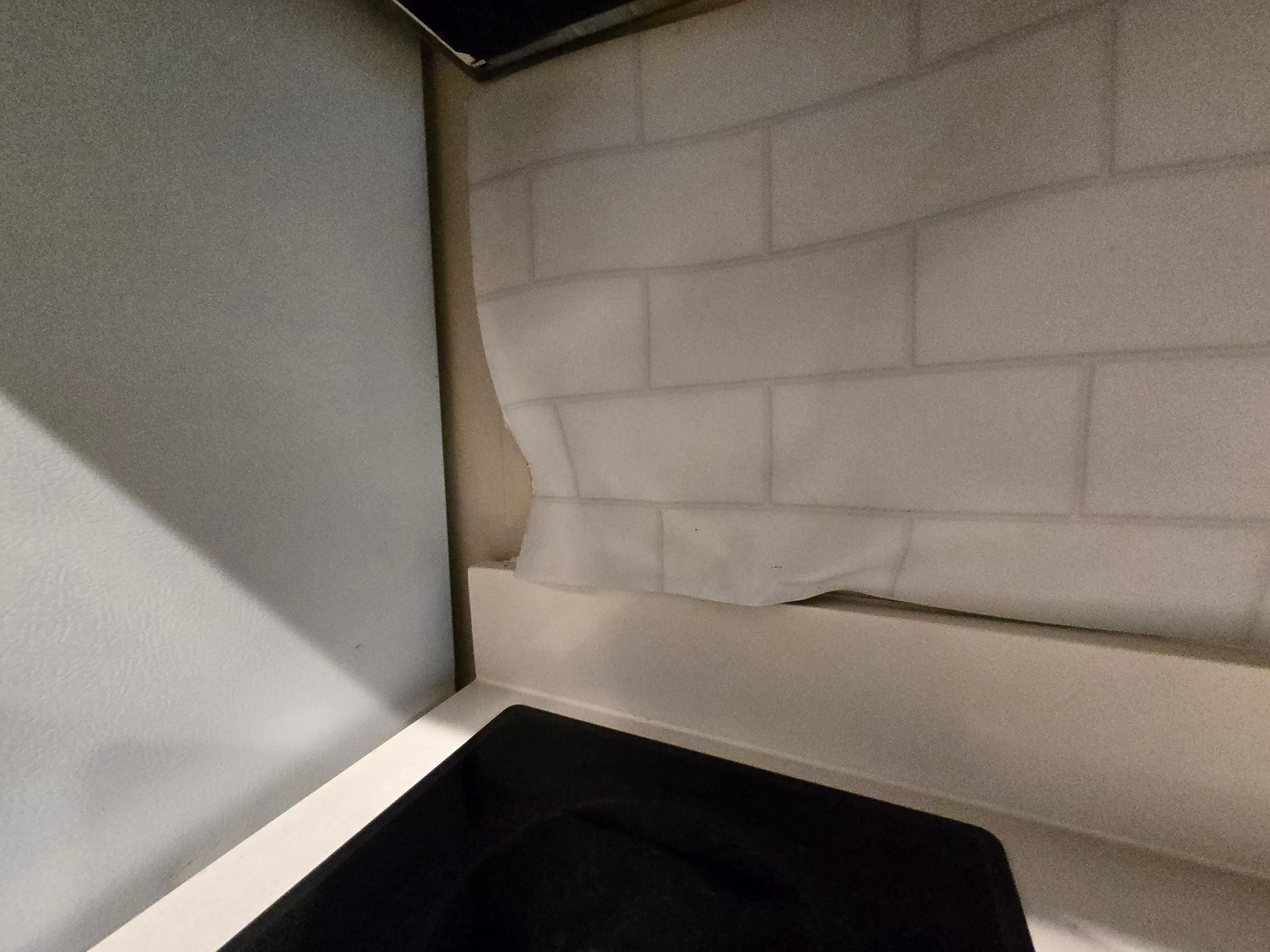 Backsplash paneling was falling off the wall.