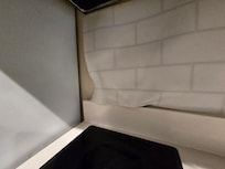 Backsplash paneling was falling off the wall.