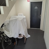 Outside the room door.