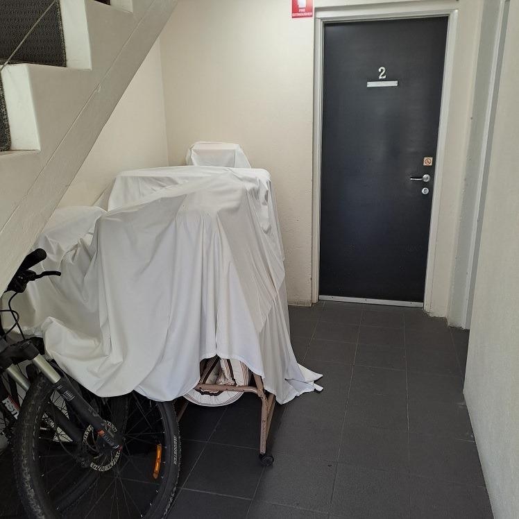 Outside the room door.