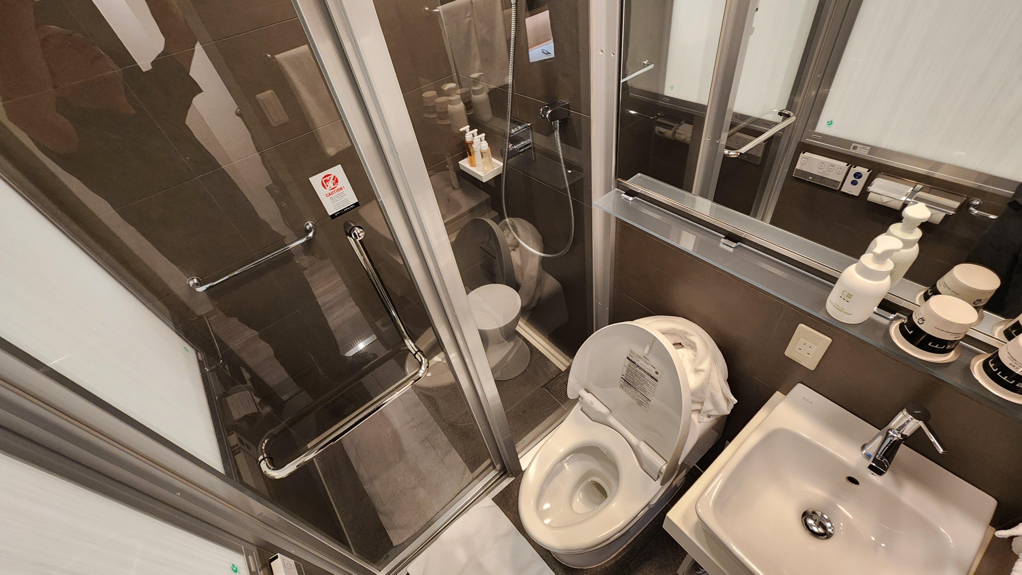 The bathroom, with a stall shower, Toto toilet and sink.  