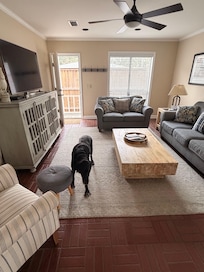 Living room with side door to fenced yard.
