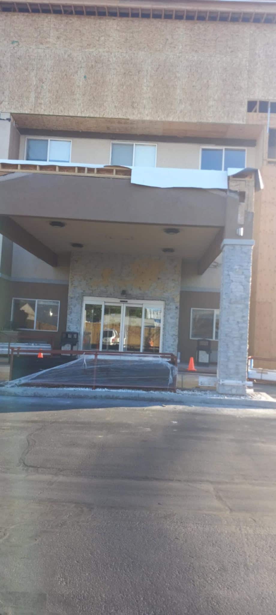 Unfinished entry way with no signage and lots of constuction materials. June 8, 2025