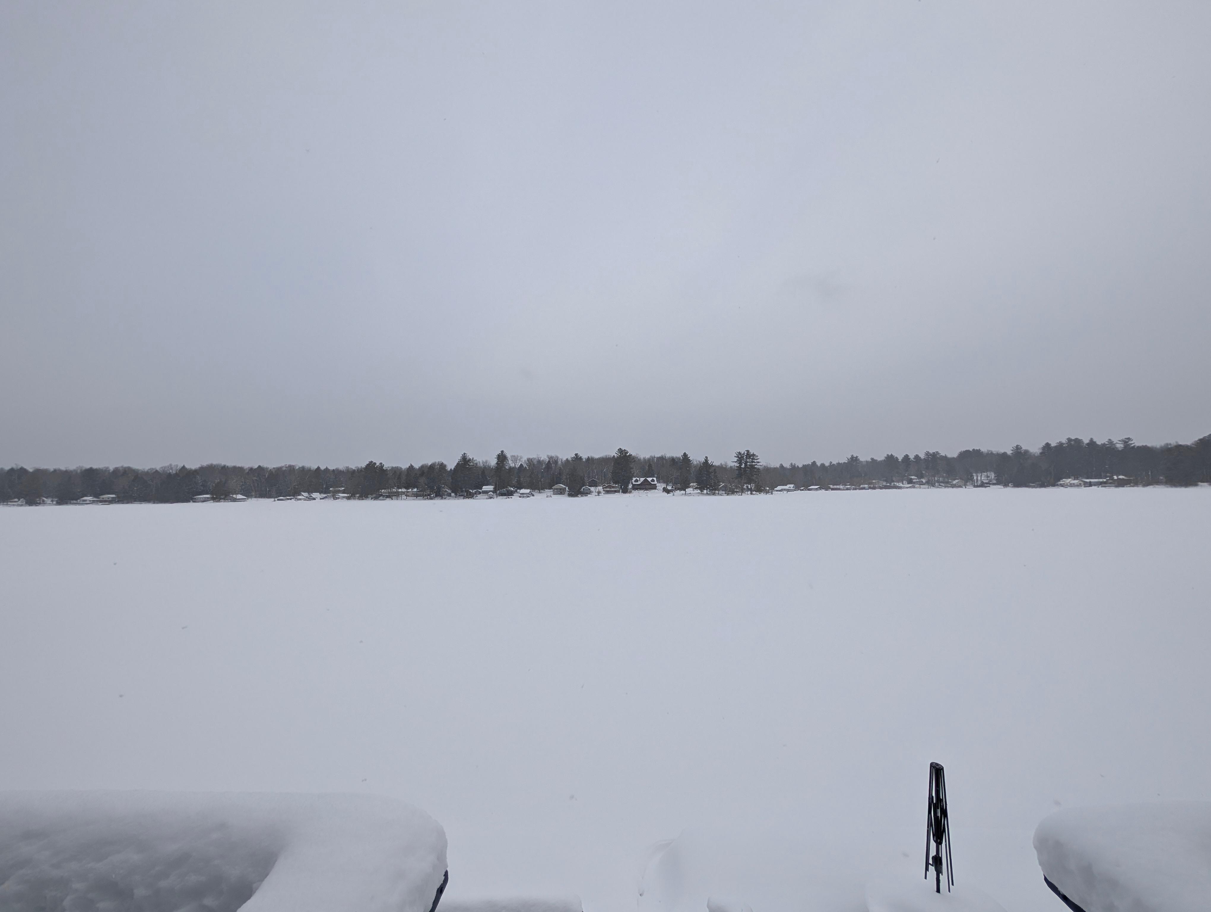Porch view of the snow covered Lake.