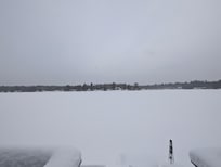 Porch view of the snow covered Lake.