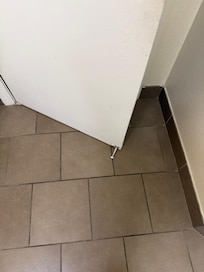 Door stopper on door drags on the floor making it hard to open door to get out of bathroom