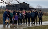 Our family with the beautiful old barn across the road