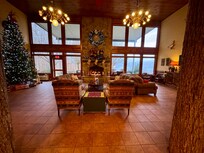 Gathering room with fireplace overlooking the lake