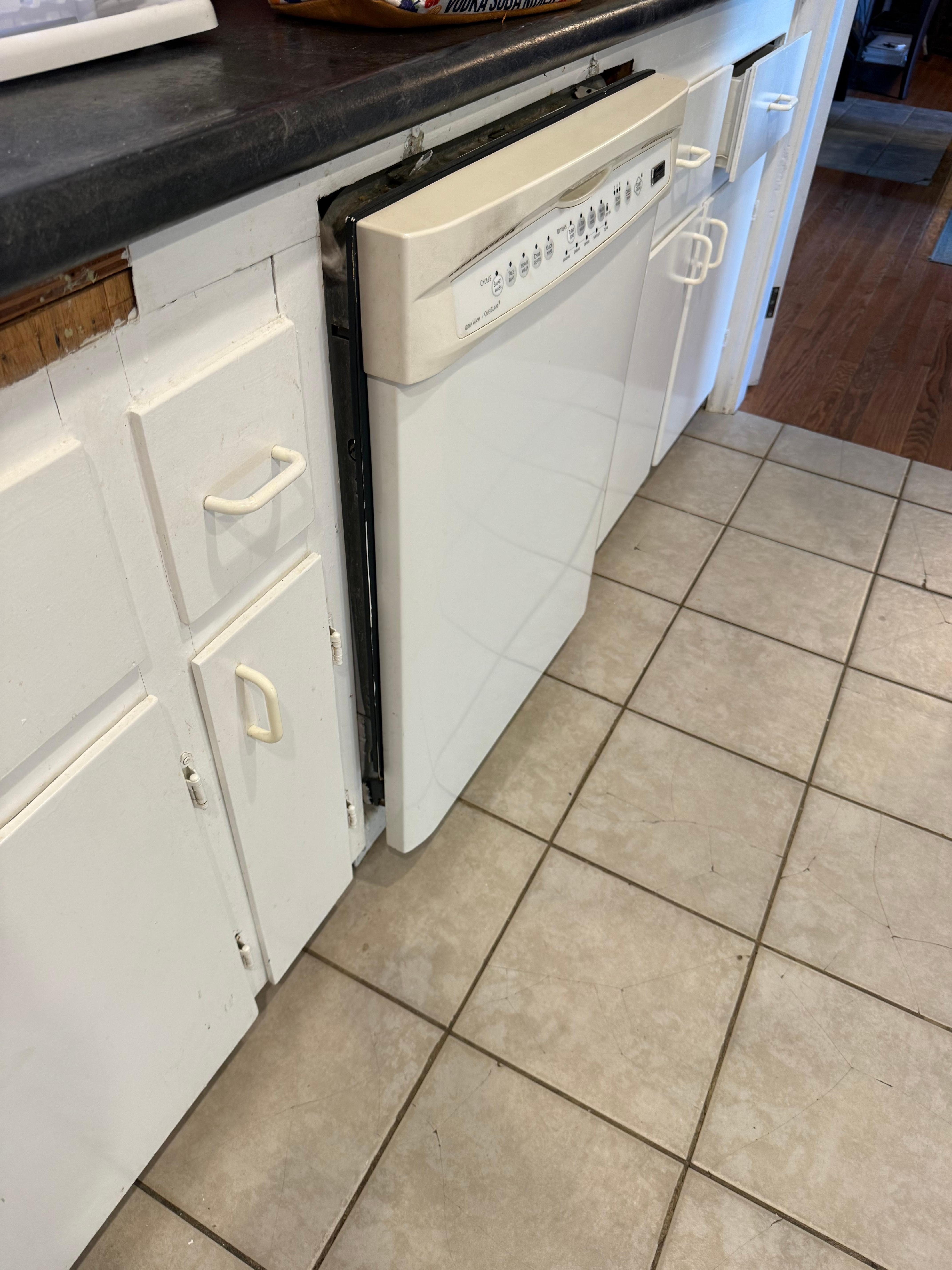 Old kitchen cabinets with the dishwasher that’s not properly installed 