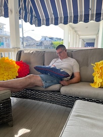 My husband enjoying the front porch!