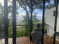 The view from inside the villa looking out the wall of glass windows