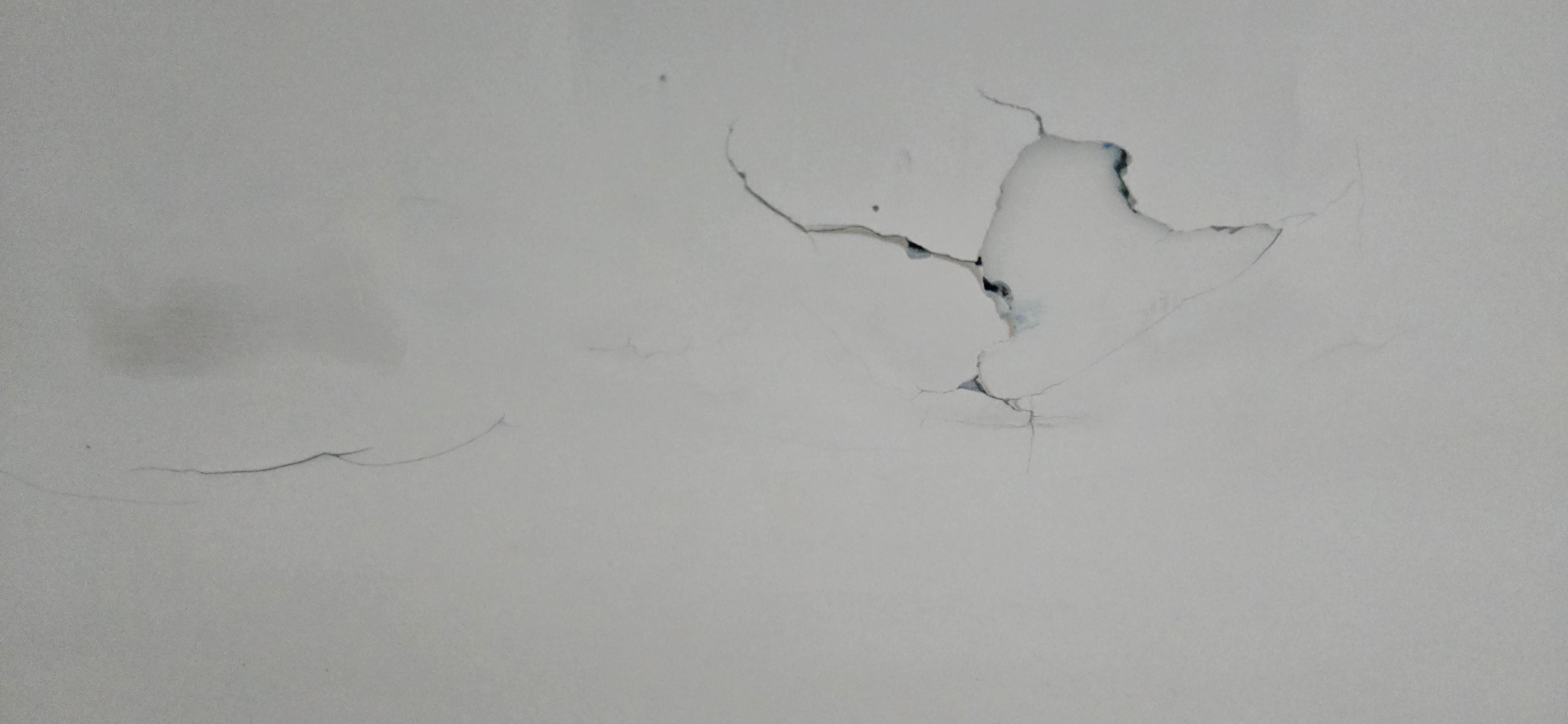 Crack / hole in tub. The tub will hold water and will leak on the floor if used as a shower.