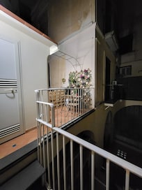 Little terrace (at night) small laundry room off to the side.