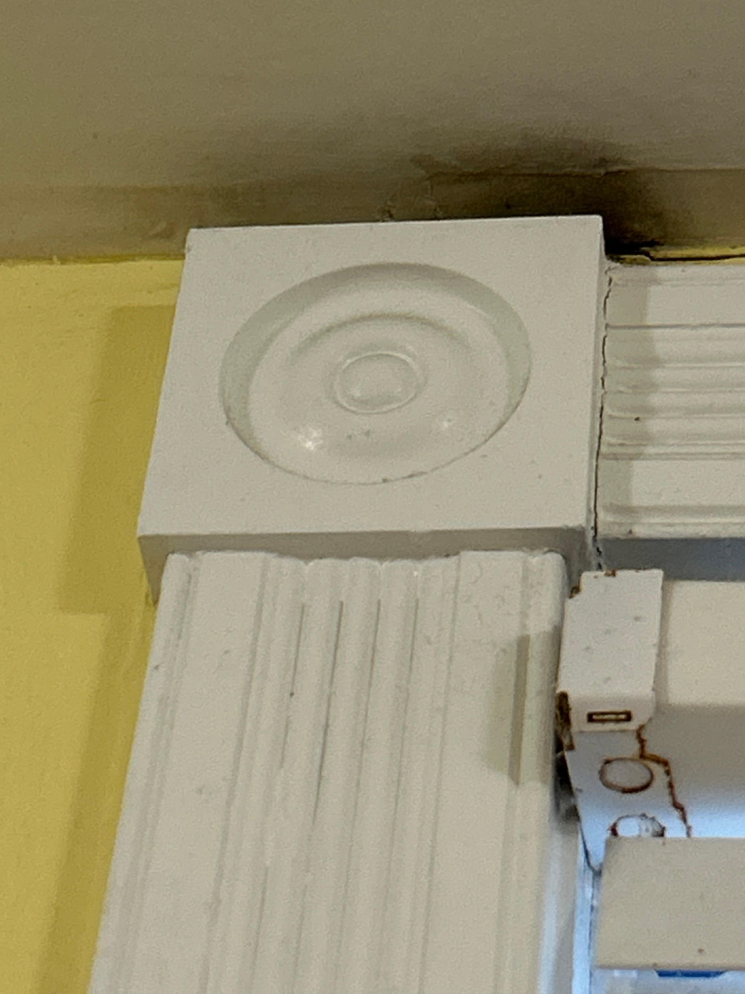 Black mold over the bedroom window near the ceiling