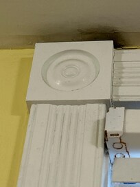 Black mold over the bedroom window near the ceiling