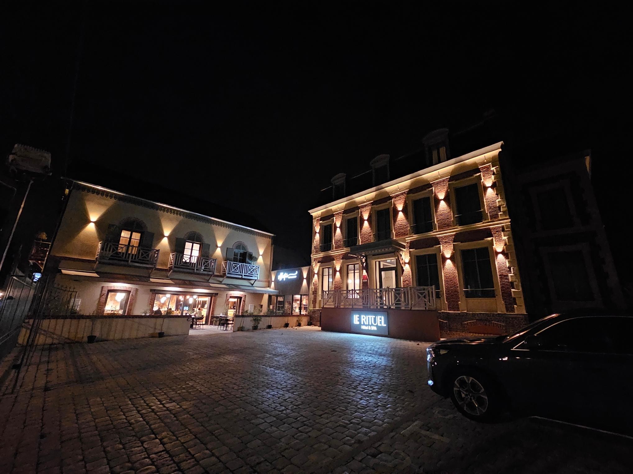 The front of this beautiful hotel/adjacent restaurant at night
