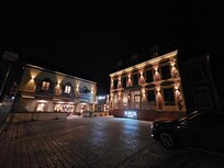 The front of this beautiful hotel/adjacent restaurant at night