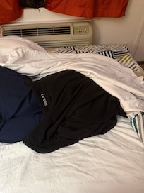 Got my jacket wrapped around my feet. The blankets are so thin. It’s cold in this room.