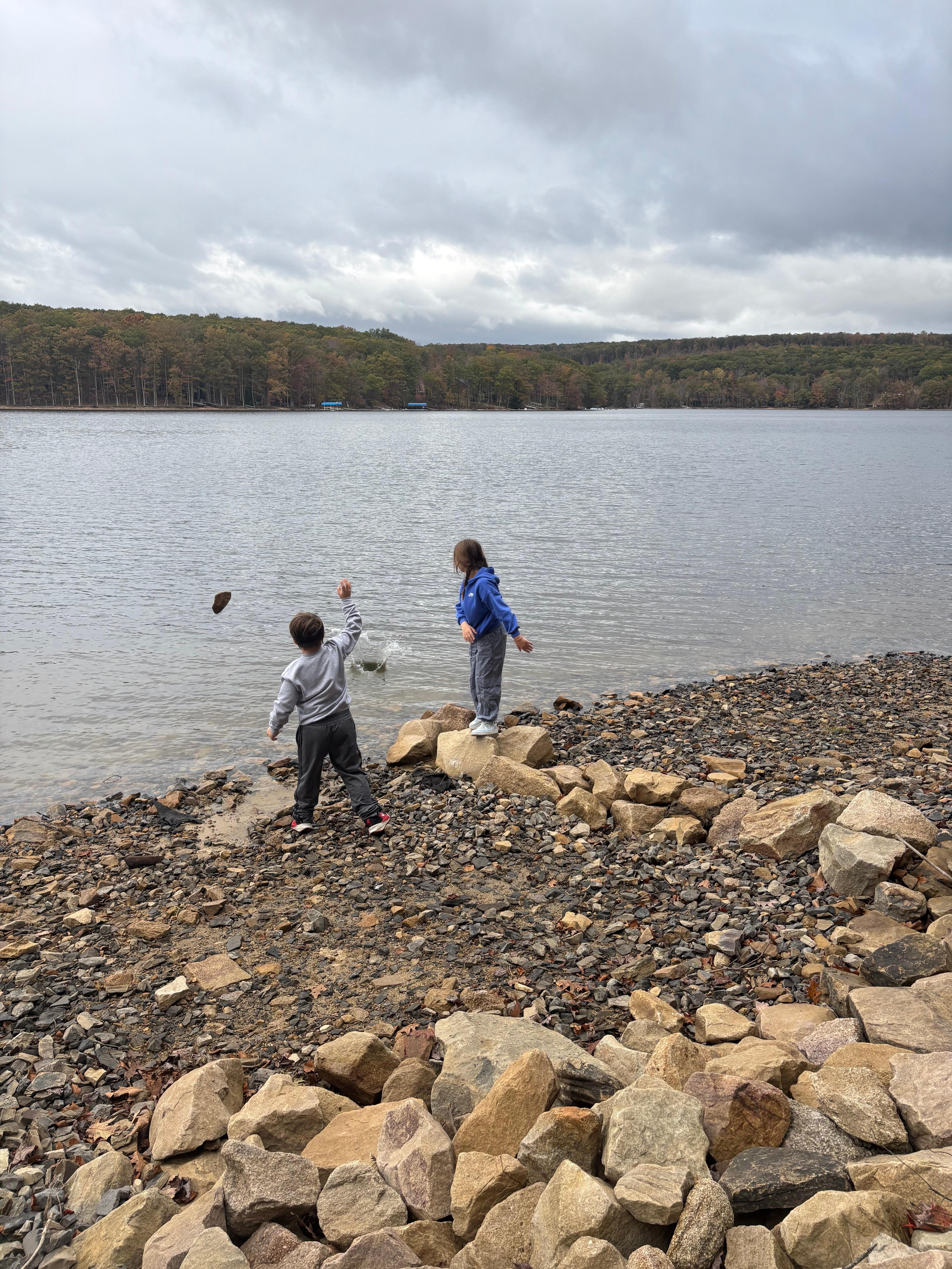 The kids enjoying skipping rocks