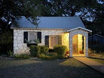 Cute rock cottage. Love the swing around the side of the house and the little cozy back porch.