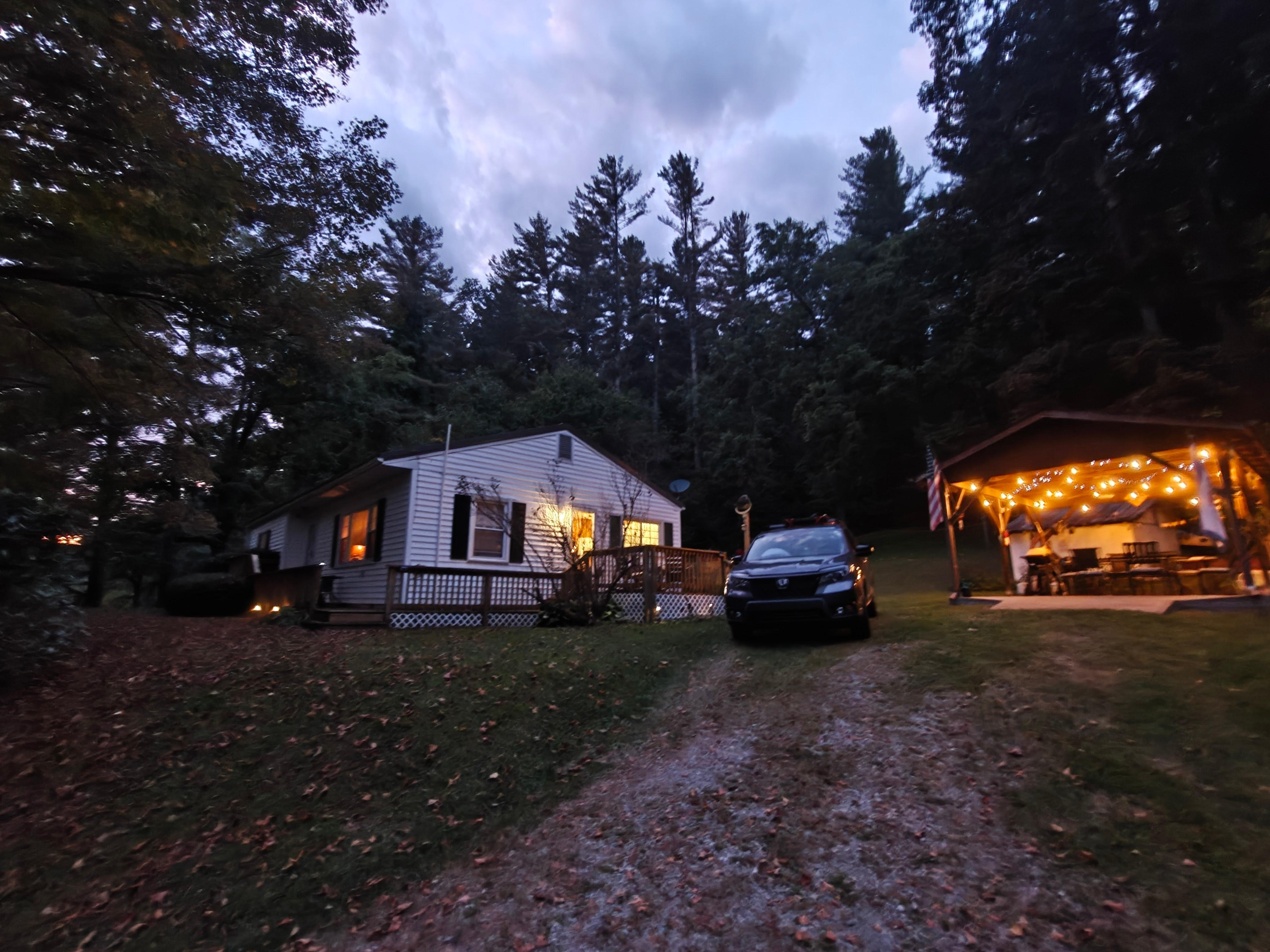 looking from the bottom of driveway towards the house.  Lights on in the sheltered picnic area
