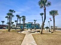 Standing at the beach looking at the place.