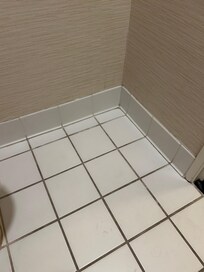 The bathroom floors have not been properly cleaned.