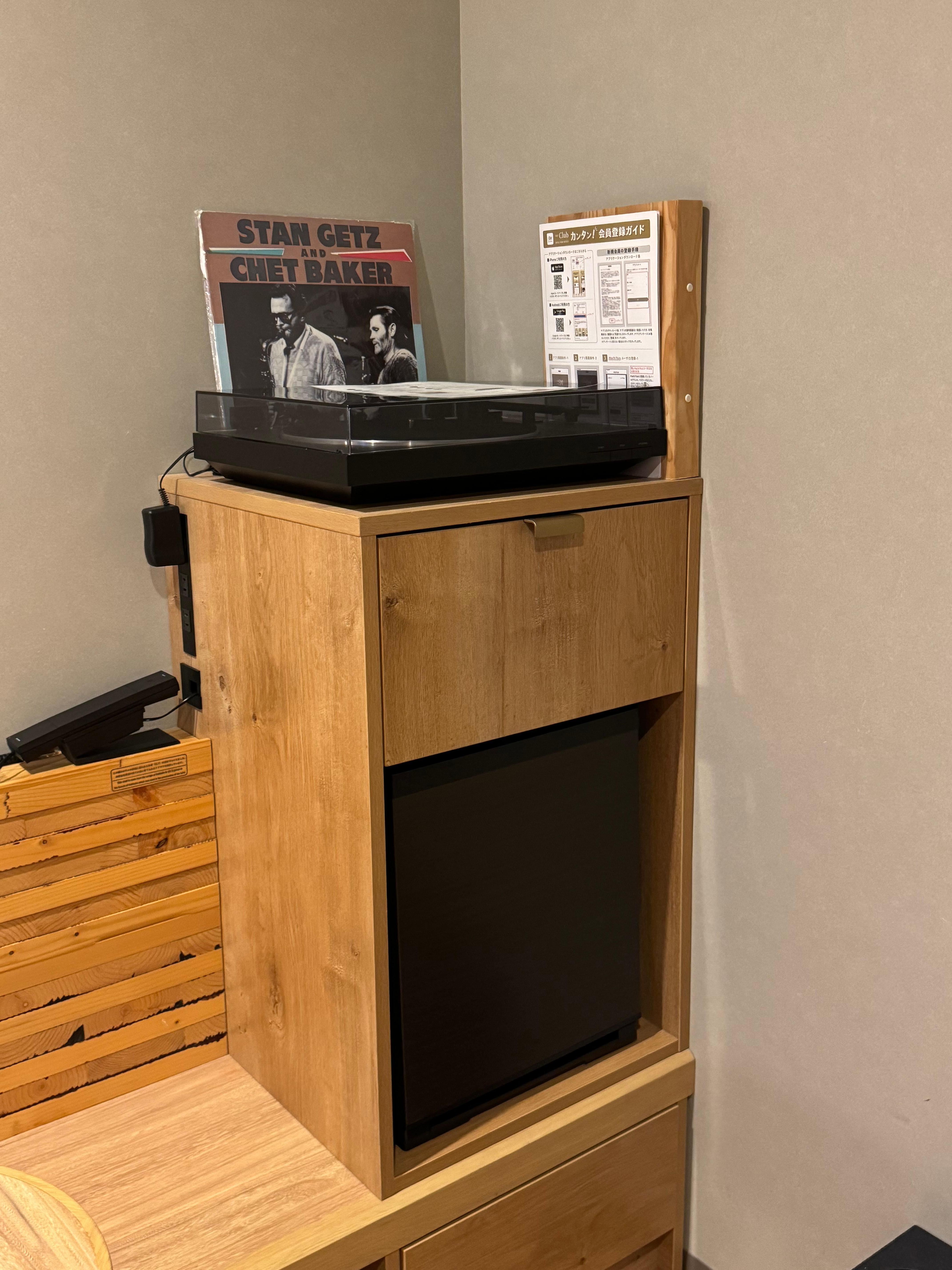 Record player with mini fridge in the room