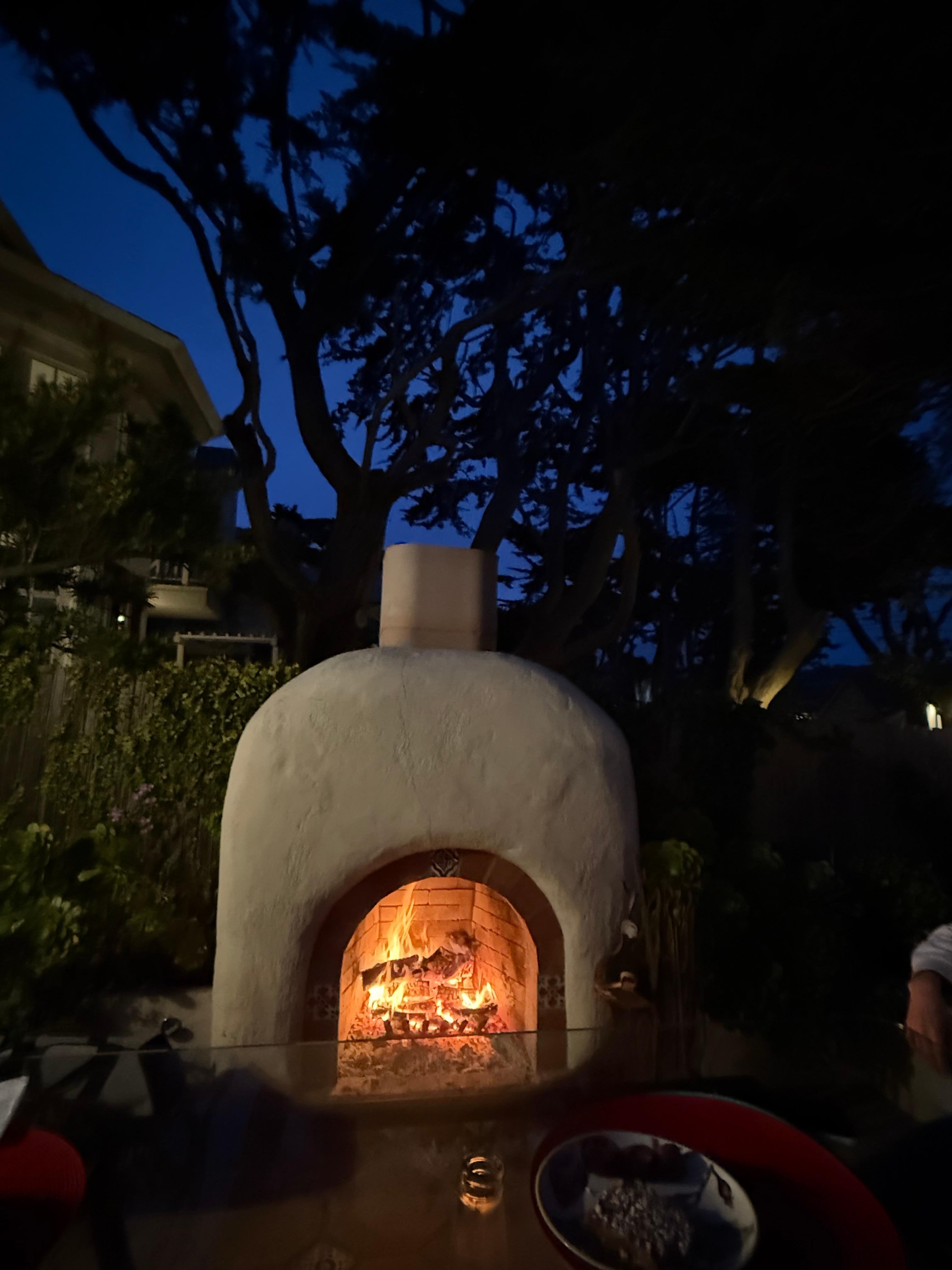 Fireplace well stocked with wood.