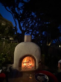 Fireplace well stocked with wood.