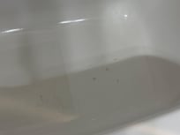 The red droplets dripped down to the tub.