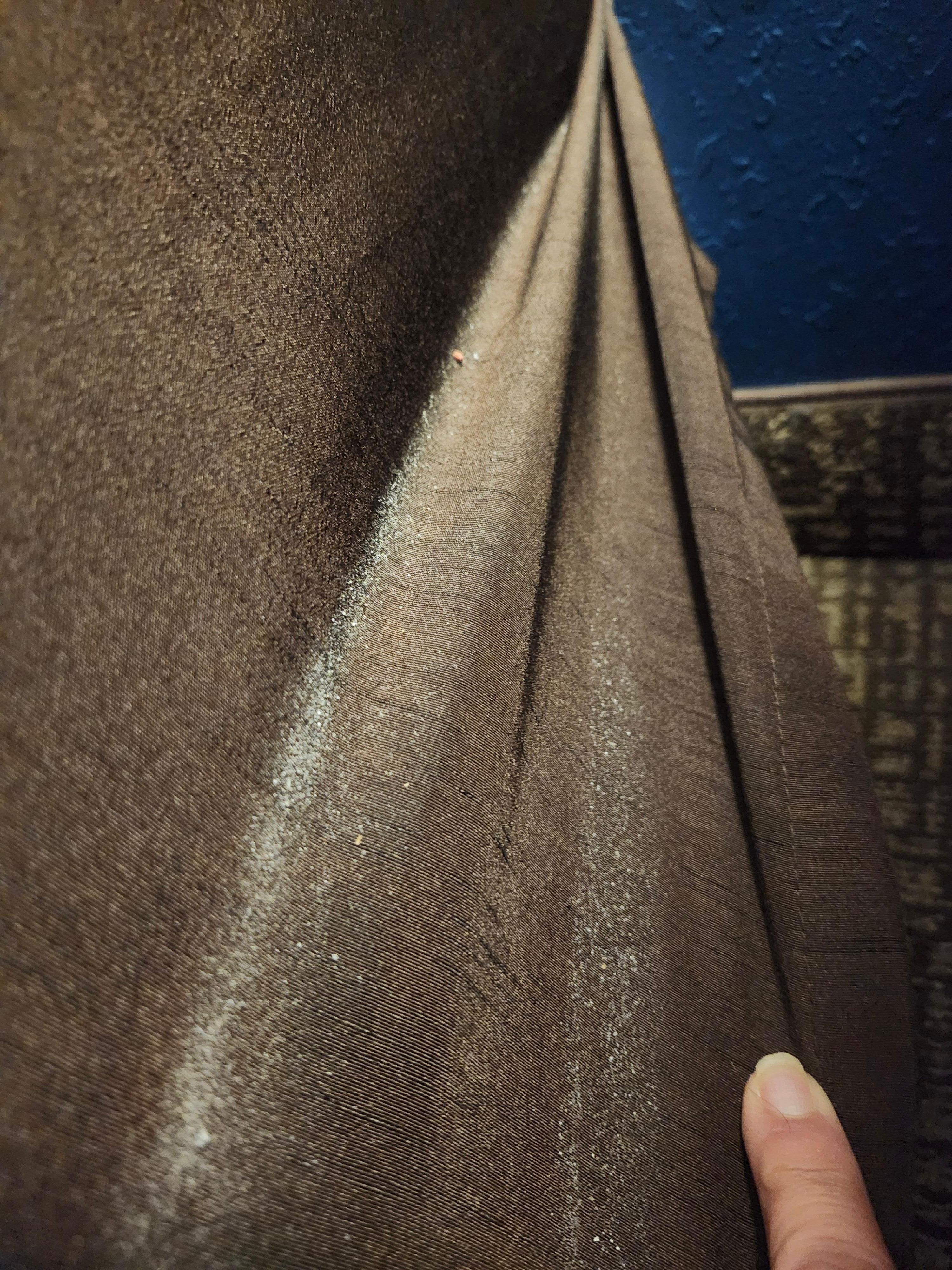 Crumbs and ashes all on the ruffle of the bed 