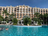 Looking east at pool 1 of 2 and west tower rooms with an ocean view